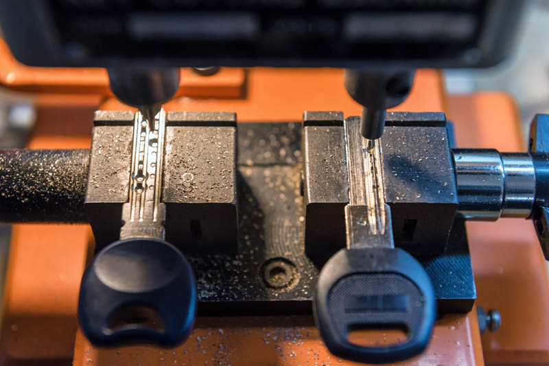 Car key copies being made on a professional key cutting machine